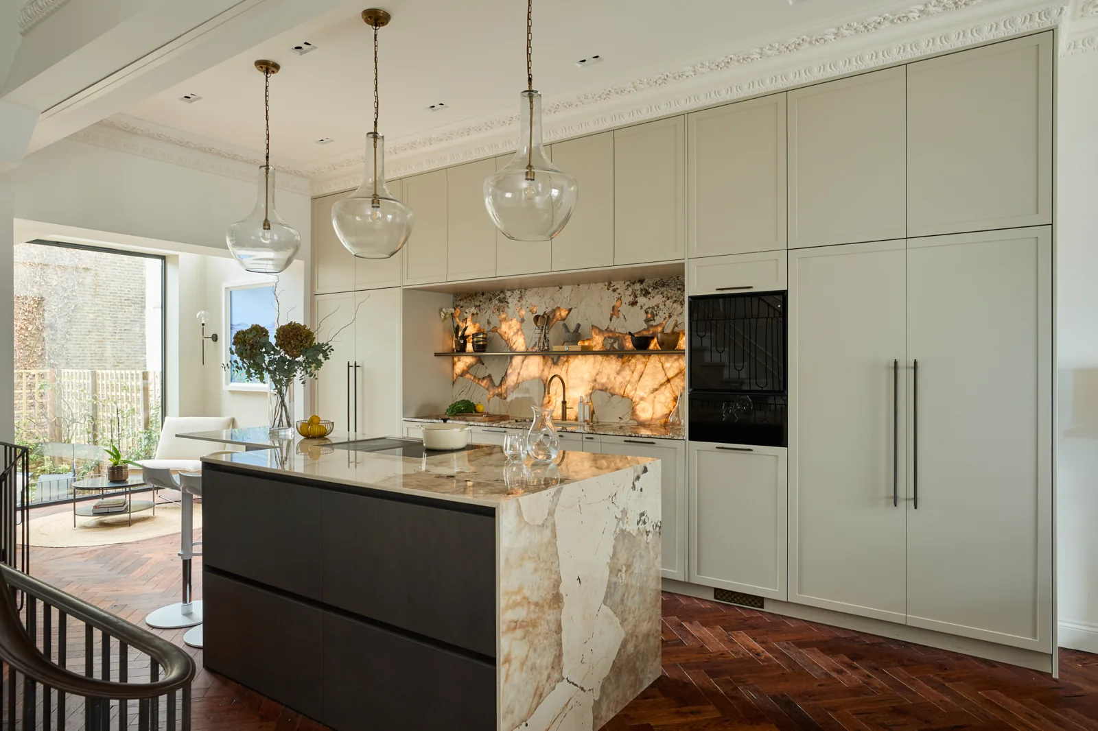 Luxury of London kitchen with pale cabinetry and a dark island